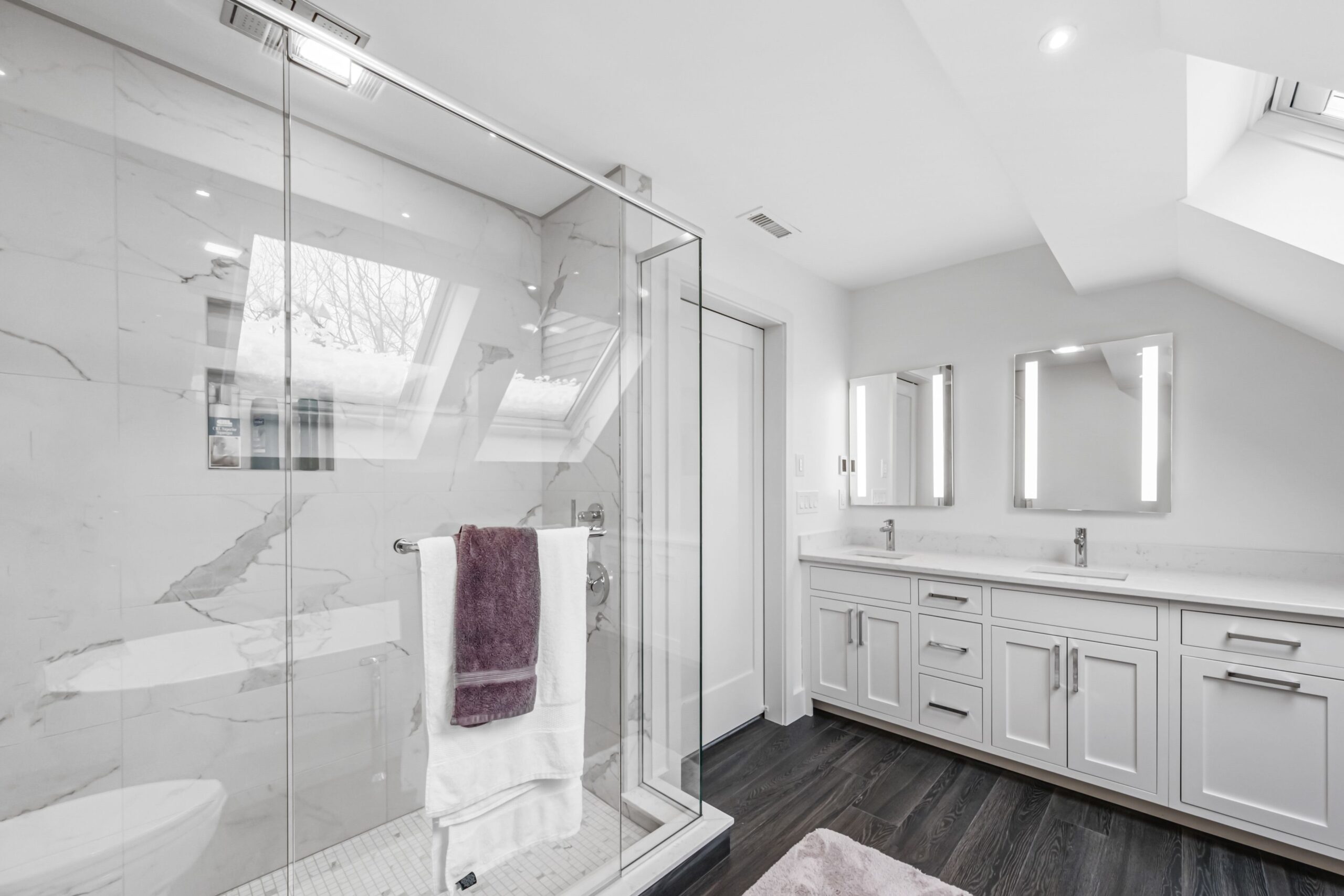 A white minimalist bathroom interior with glass partition